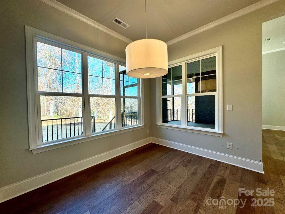 3850 Willow Grove Lane, Unit 24 Concord, NC 28025 - Photo 19 of 40 a view of an empty room with wooden floor and a window