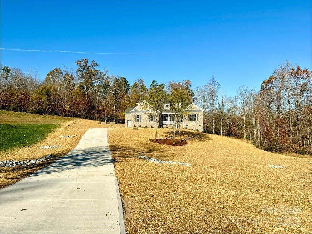 3850 Willow Grove Lane, Unit 24 Concord, NC 28025 - Photo 3 of 40 a view of swimming pool with outdoor seating and house in the background