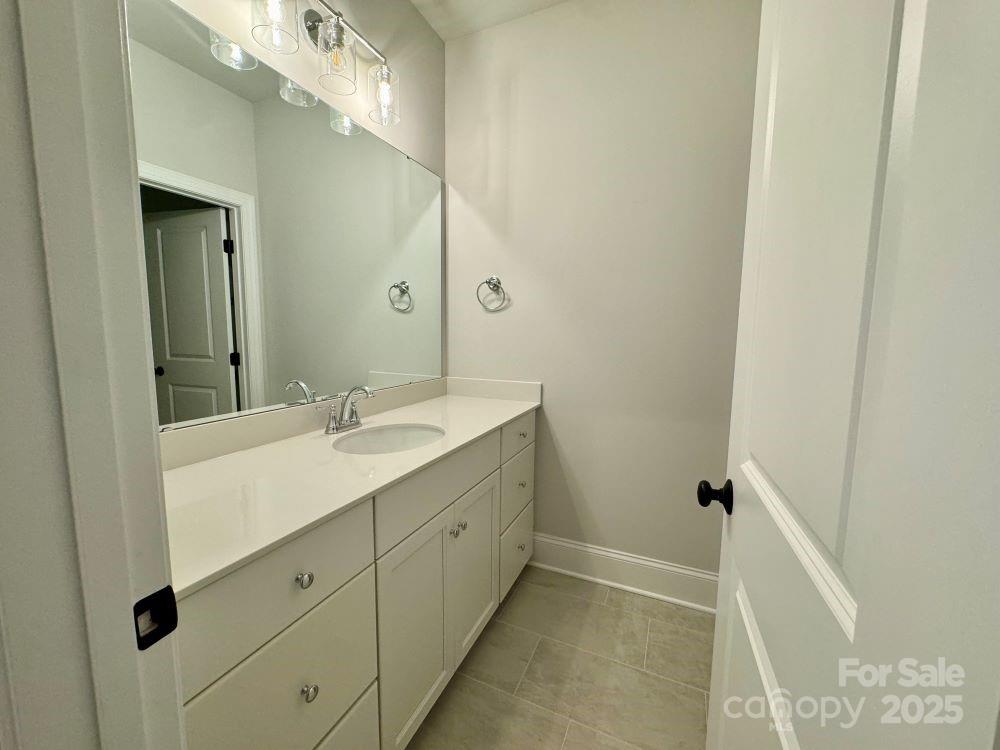 3850 Willow Grove Lane, Unit 24 Concord, NC 28025 - Photo 32 of 40 a bathroom with a double vanity sink a mirror and a shower