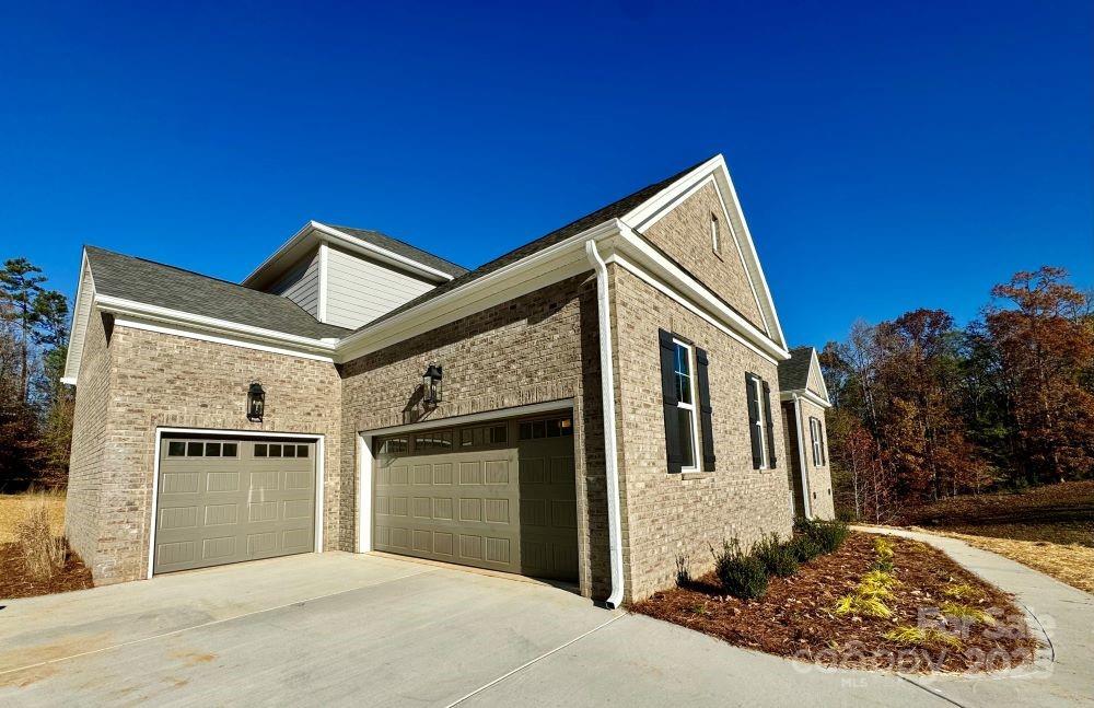 3850 Willow Grove Lane, Unit 24 Concord, NC 28025 - Photo 4 of 40 a front view of a house with a yard