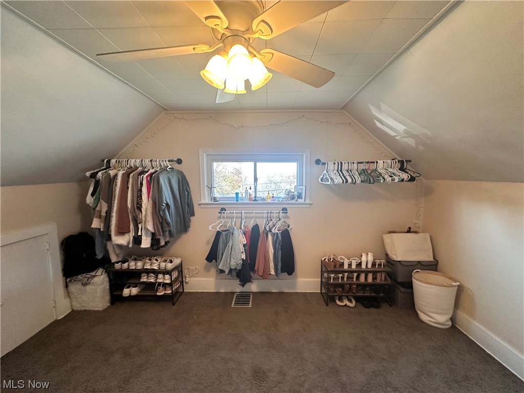 174 Powers Road Weirton, WV 26062 - Photo 28 of 33 Walk in closet with ceiling fan, vaulted ceiling, and dark carpet