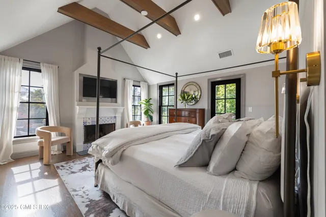 a bedroom with a bed couch and a window