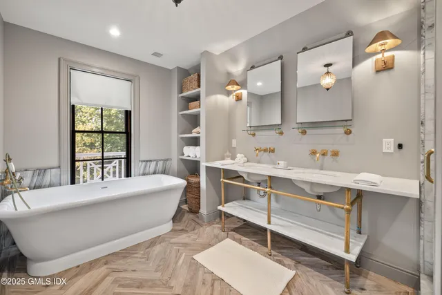 a spacious bathroom with a double vanity sink mirror and double