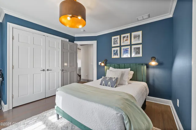 a bedroom with a bed and a lamp