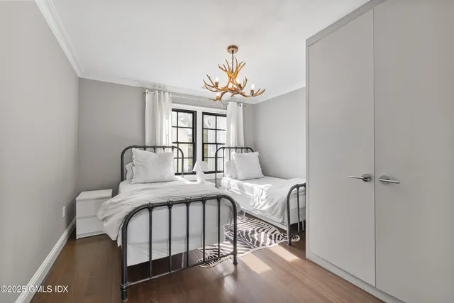 a bedroom with a bed and a chandelier