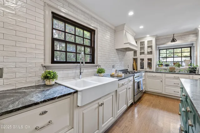 a kitchen with sink a window and appliances