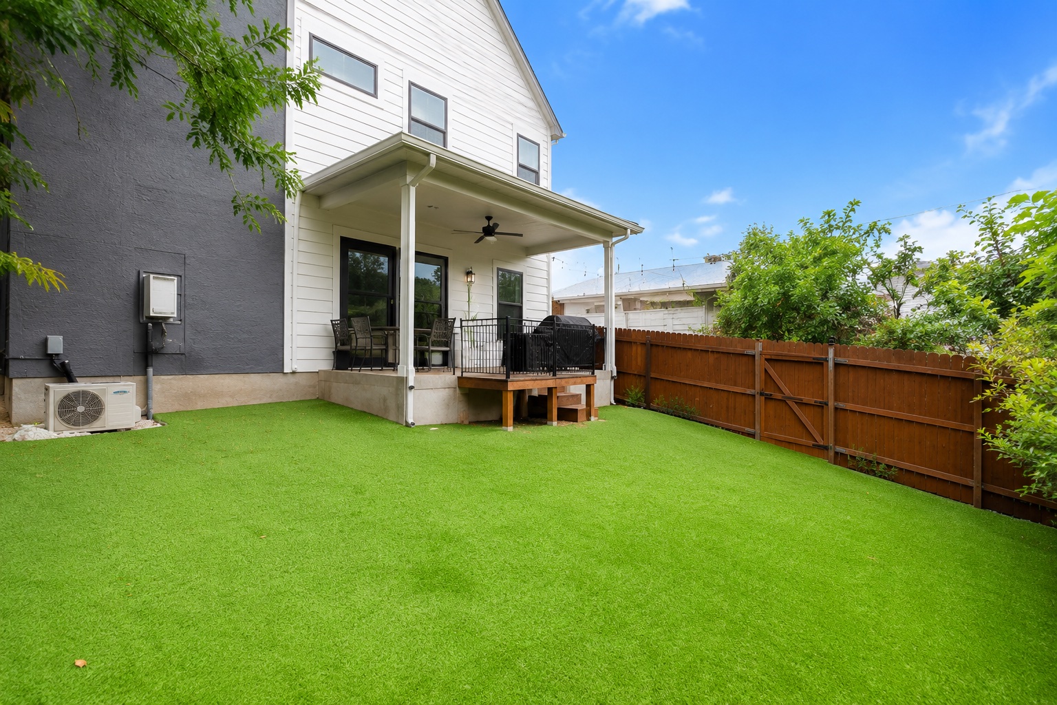 5007 Lott Avenue, Unit 1 Austin, TX 78721 - Photo 23 of 24 A well-maintained fenced yard boasts a comfortable covered patio, perfect for outdoor enjoyment.