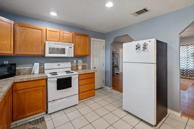 a kitchen with a refrigerator sink and microwave
