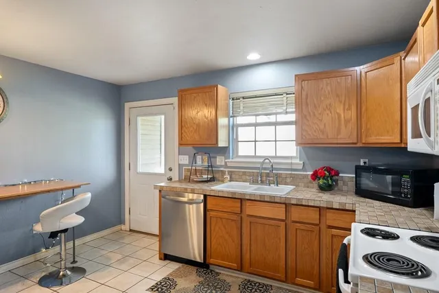 a kitchen with a sink cabinets and window