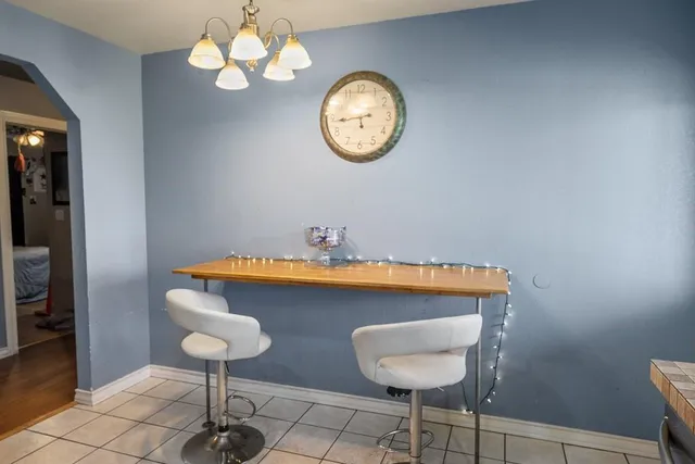 a view of a kitchen with a table and a chair