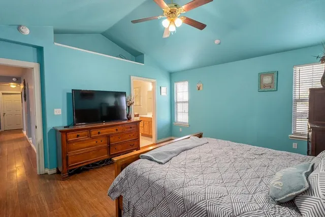 a bedroom with a bed and a flat screen tv