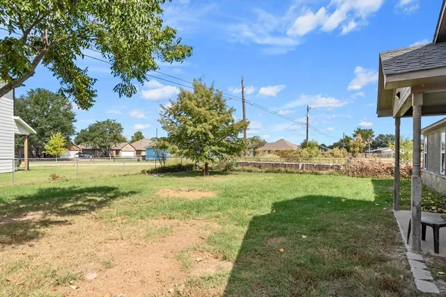 a front view of a house with yard and green space