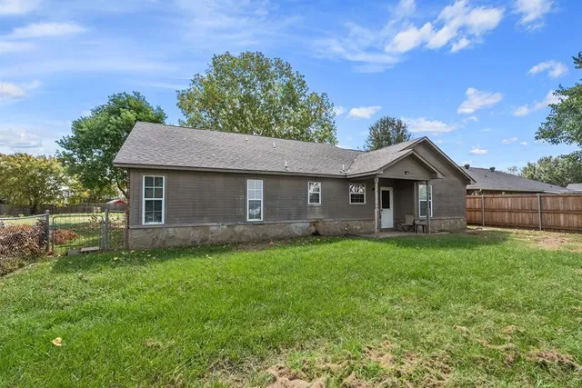 a front view of a house with yard and green space