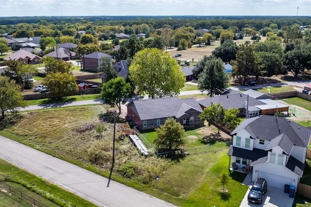 an aerial view of a house with a garden and lake view