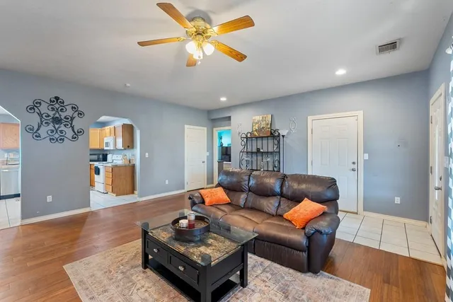 a living room with furniture and wooden floor