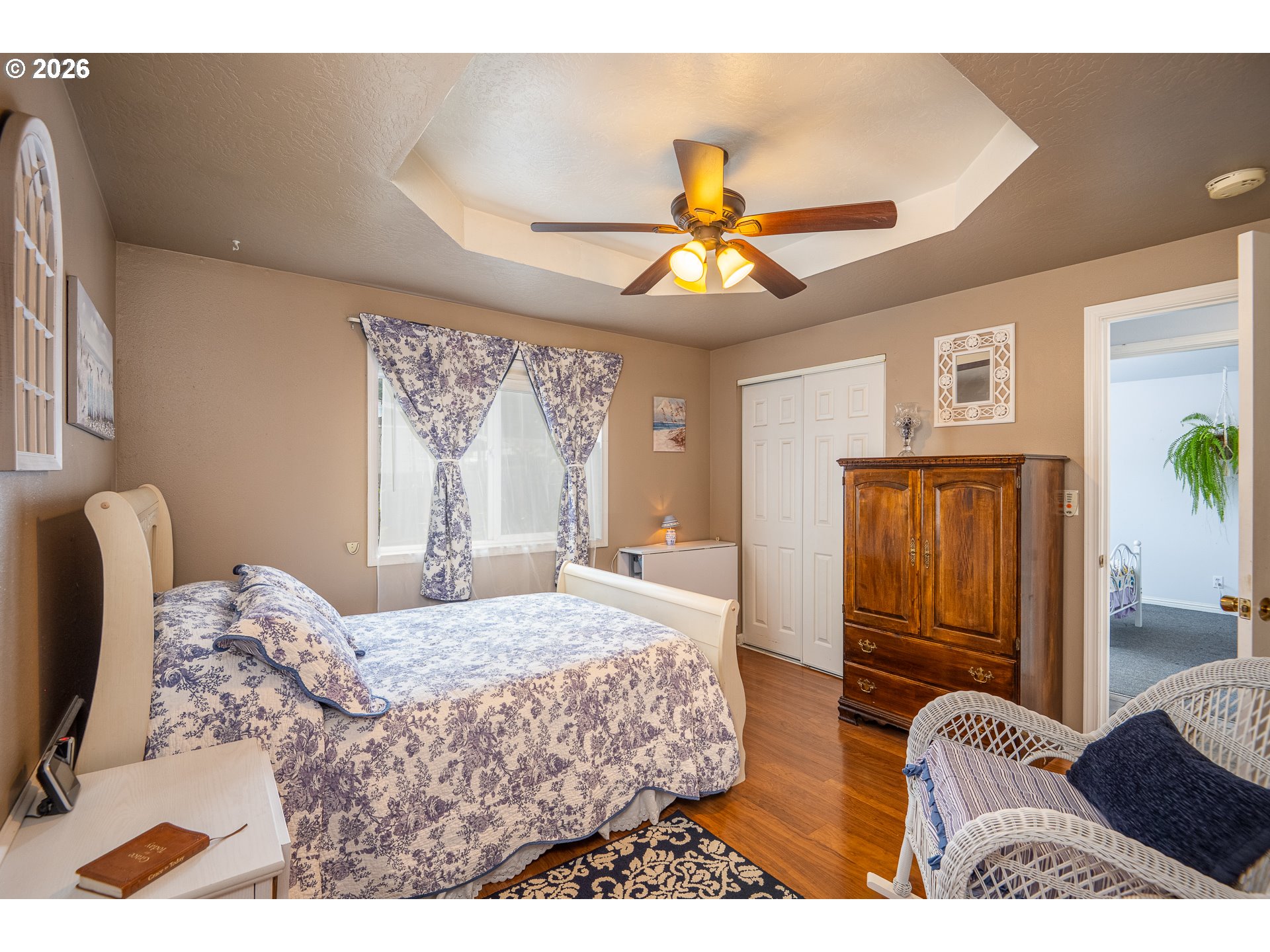 90 South 17th Street Cottage Grove, OR 97424 - Photo 9 of 23 a bedroom with a bed and a chandelier