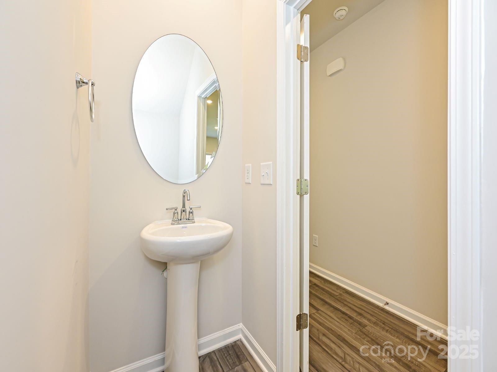 1413 Old Rivers Road Concord, NC 28027 - Photo 2 of 20 a bathroom with a sink a mirror and a mirror