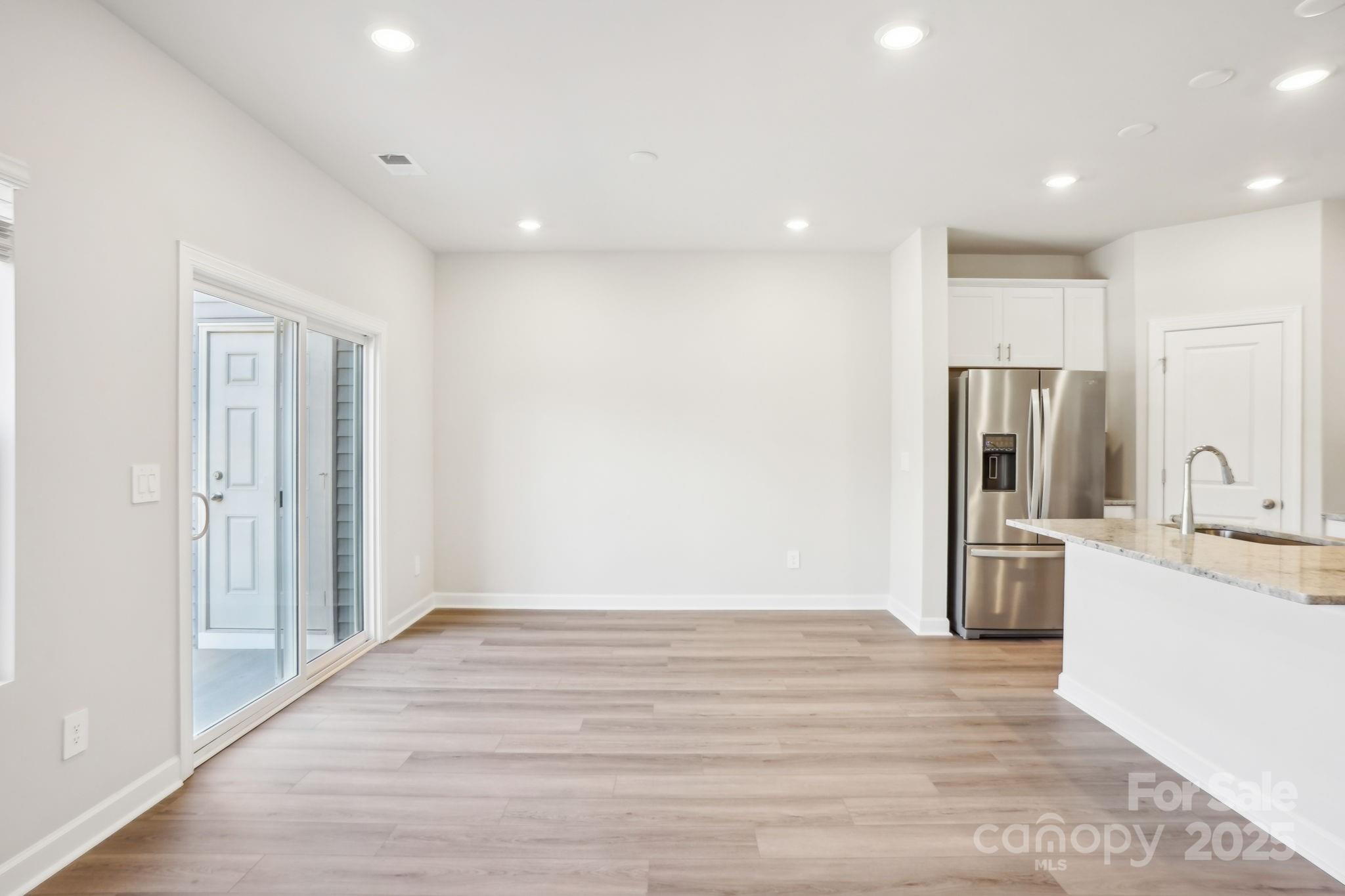 1413 Old Rivers Road Concord, NC 28027 - Photo 5 of 20 a view of a kitchen with a sink refrigerator and wooden floor
