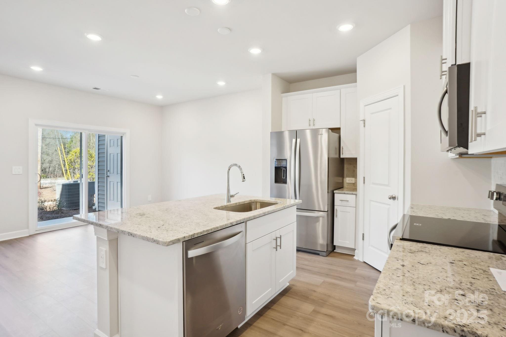 1413 Old Rivers Road Concord, NC 28027 - Photo 7 of 20 a kitchen with stainless steel appliances granite countertop a refrigerator sink and stove