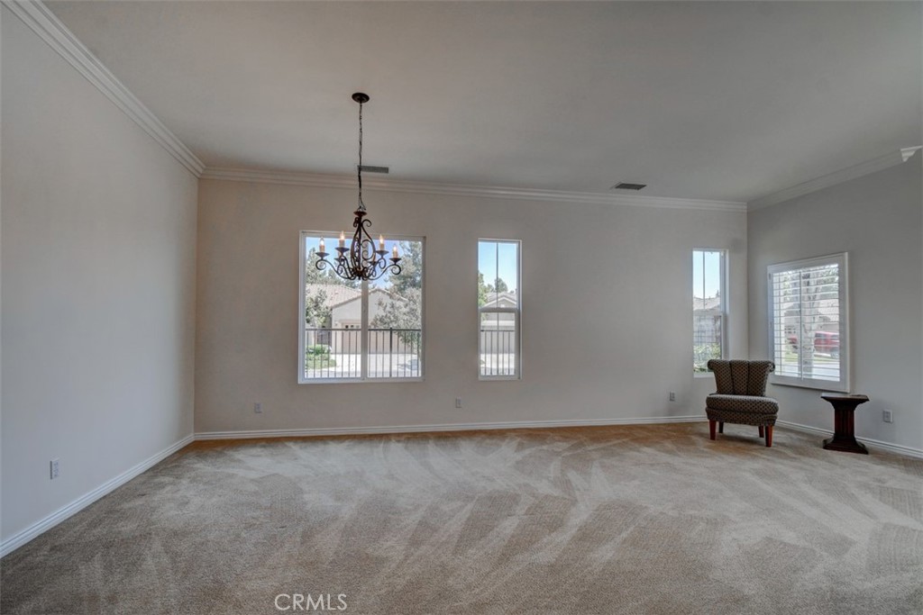 9152 Deergrass Street Corona, CA 92883 - Photo 13 of 32 an empty room with windows and furniture