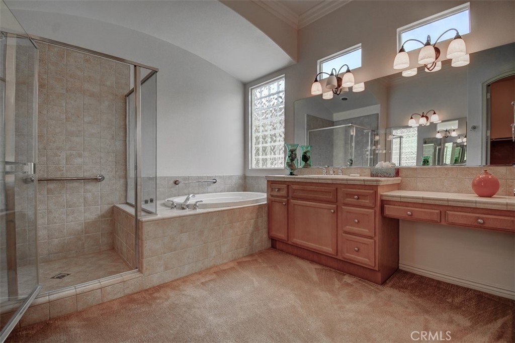 9152 Deergrass Street Corona, CA 92883 - Photo 20 of 32 a bathroom with a granite countertop sink a large mirror and a bathtub