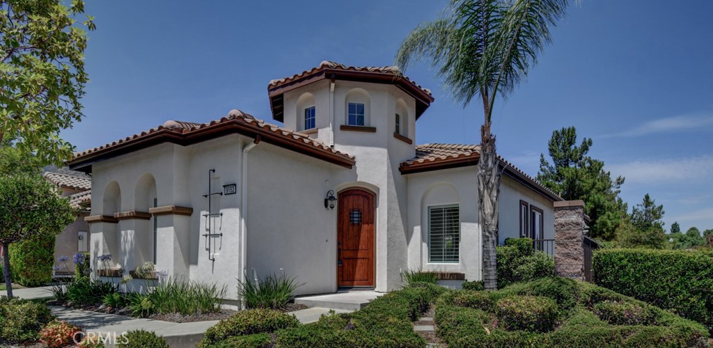 9152 Deergrass Street Corona, CA 92883 - Photo 3 of 32 a front view of a house with a garden