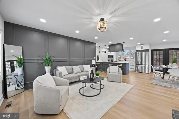 a living room with furniture a dining table and kitchen view