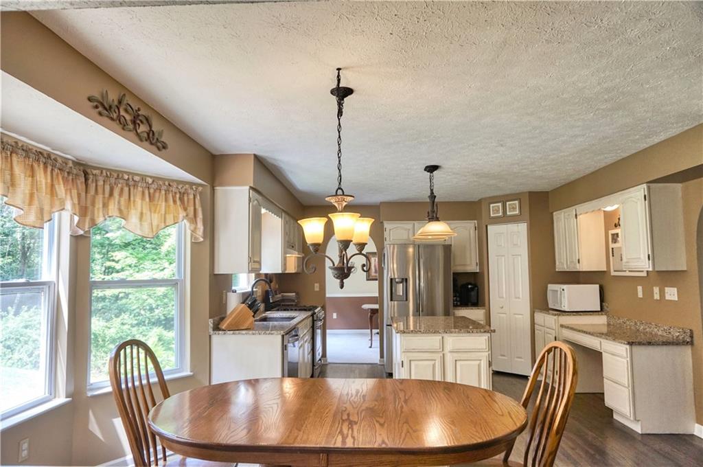 1123 Rural Ridge Drive Cheswick, PA 15024 - Photo 7 of 21 Beautiful updated eat-in kitchen with hardwood floors, granite, distressed look painted cabinets, sink with disposal and stainless appliances!
