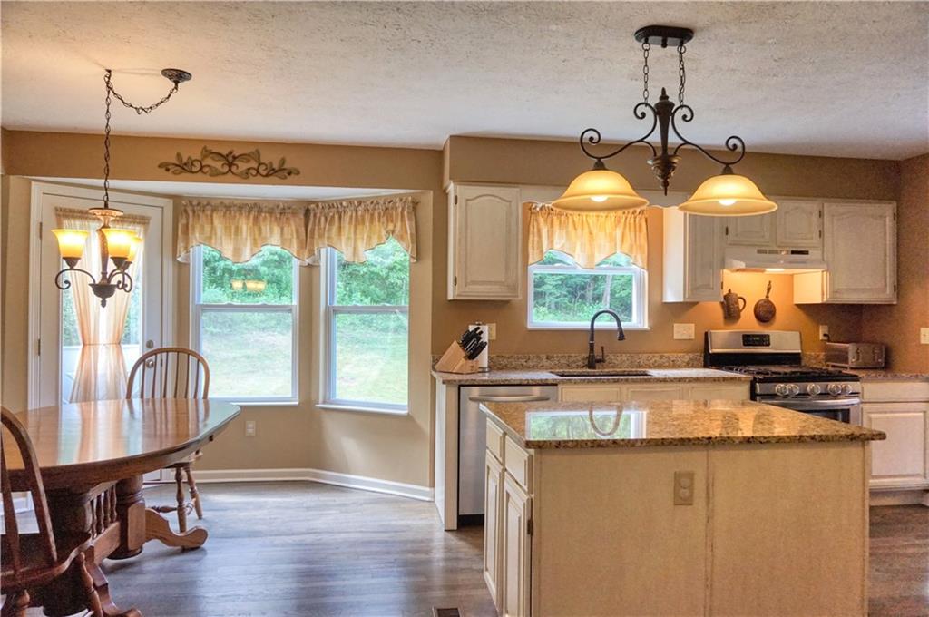 1123 Rural Ridge Drive Cheswick, PA 15024 - Photo 8 of 21 The breakfast nook features a bay window with door to the rear omni stone patio! Spacious island and granite throughout the kitchen!