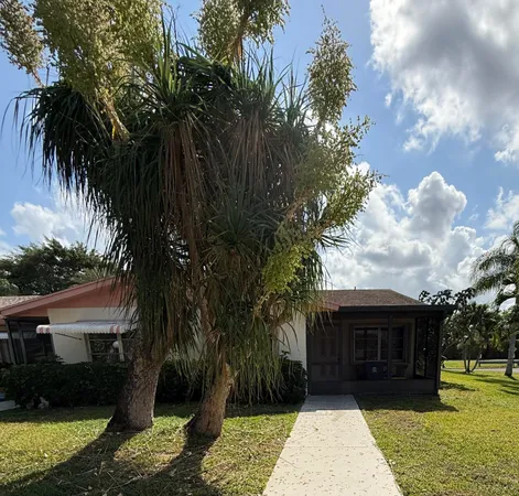 a view of house with backyard space and garden