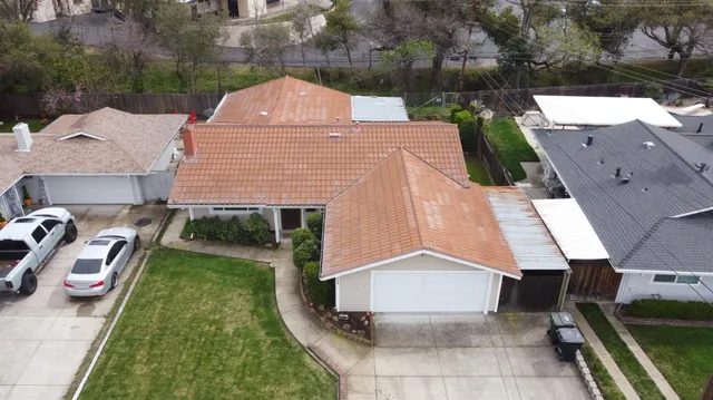 an aerial view of a house with a yard