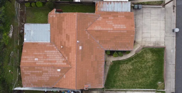 view of a brick house with a yard