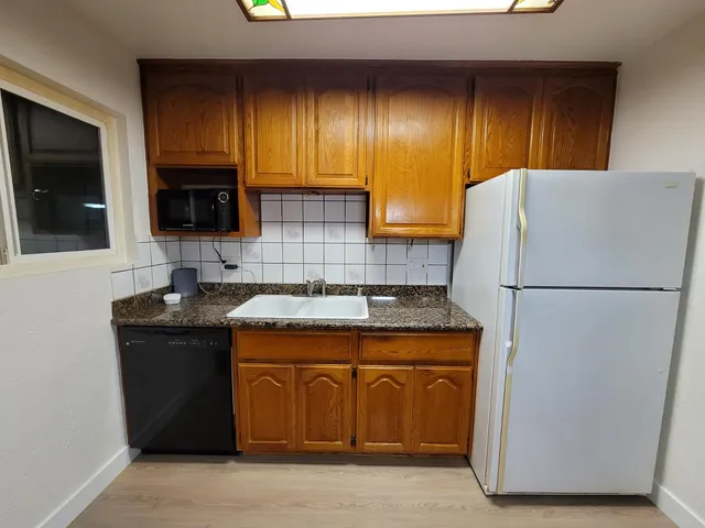 a kitchen with a refrigerator and a sink