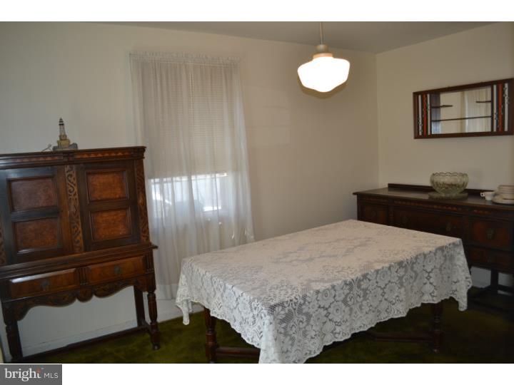 27 Golf Road Darby, PA 19023 - Photo 3 of 12 a bedroom with a bed and a dresser