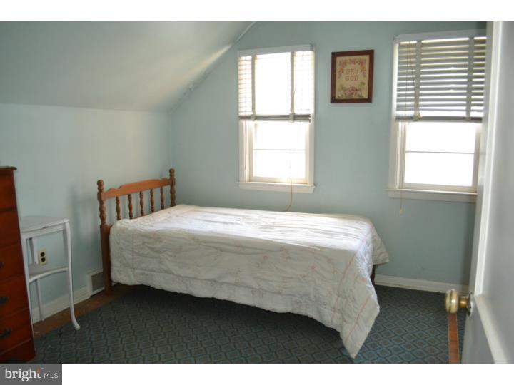 27 Golf Road Darby, PA 19023 - Photo 8 of 12 a bedroom with a bed next to a window