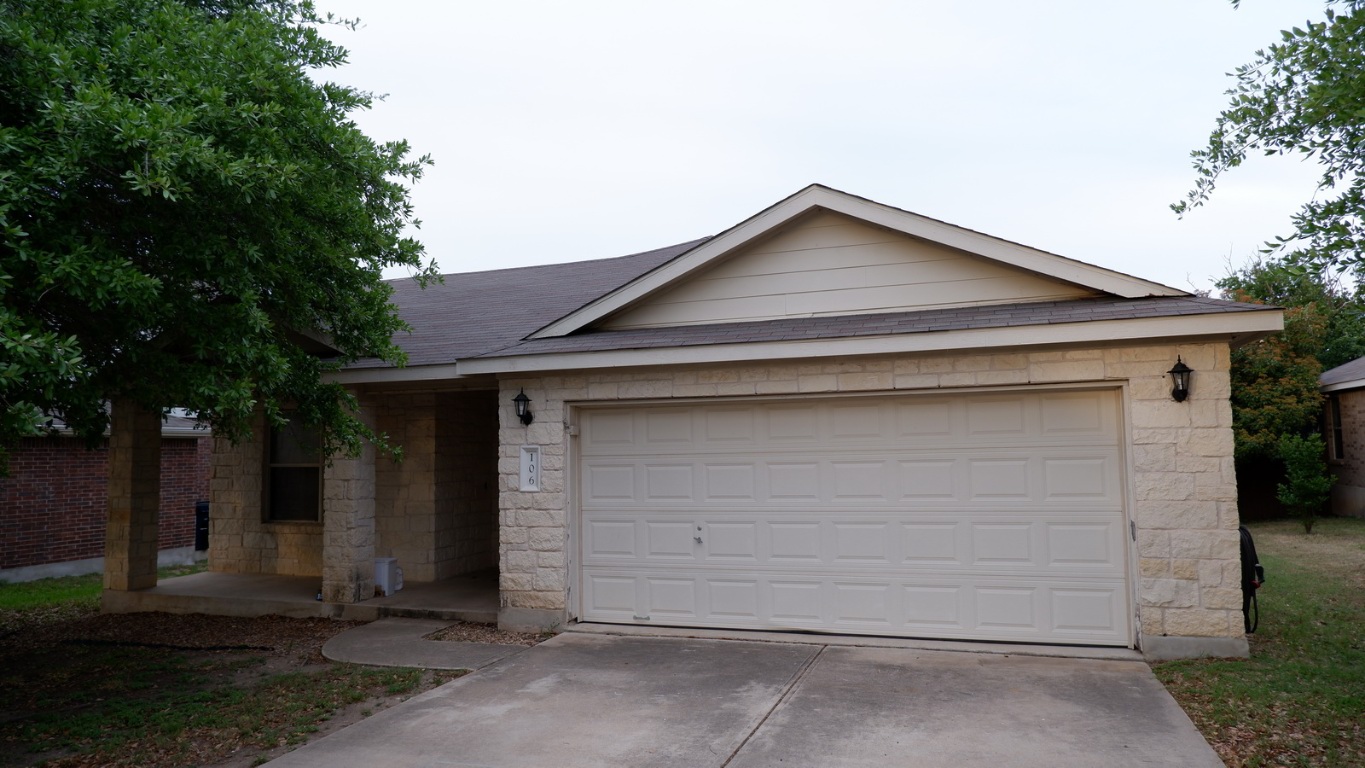 a front view of a house with garage
