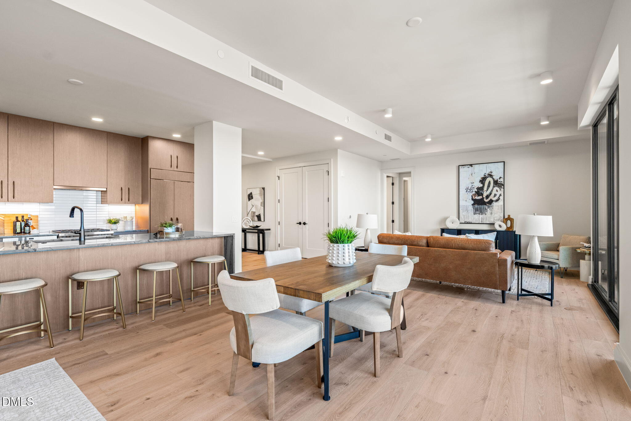 a living room with lots of furniture and view of kitchen