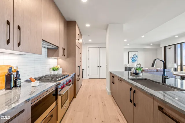 a stove top oven sitting inside of a kitchen