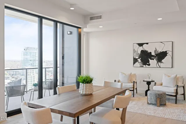 a living room with furniture and a dining table with kitchen view