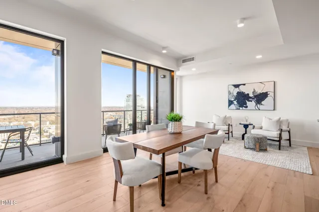 a living room with furniture a dining table and kitchen view