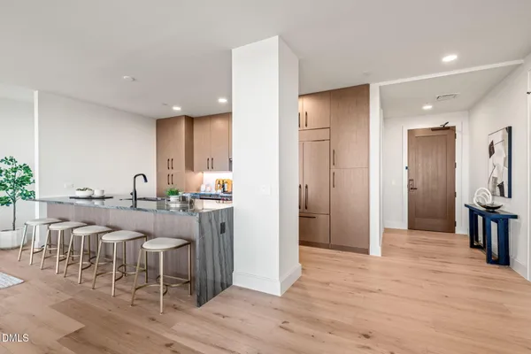 a kitchen with stainless steel appliances granite countertop a sink stove and cabinets