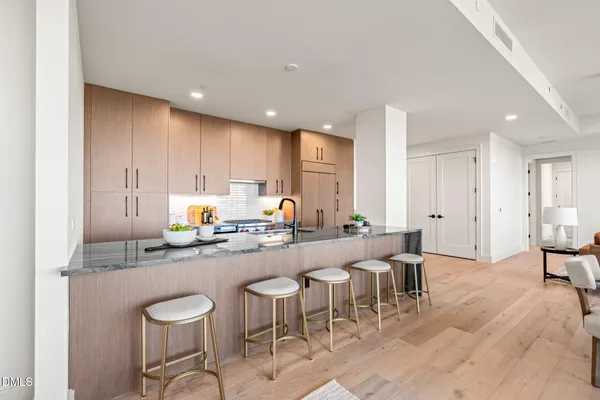 a kitchen with stainless steel appliances a refrigerator and a stove top oven