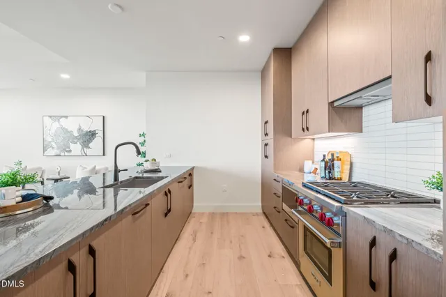 a kitchen with sink attached with living room