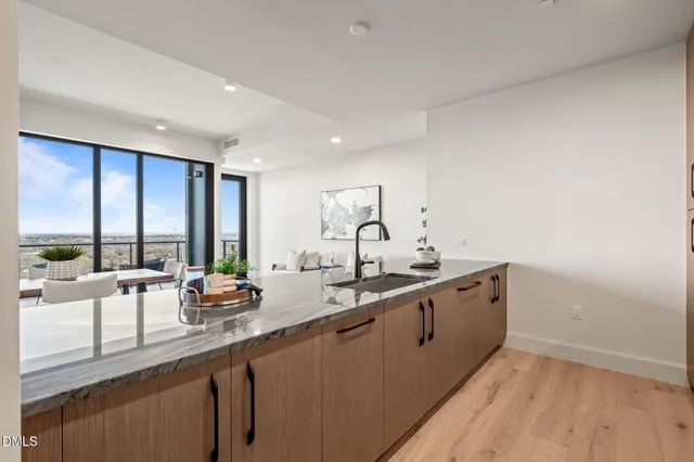 a kitchen with stainless steel appliances granite countertop a sink stove and cabinets
