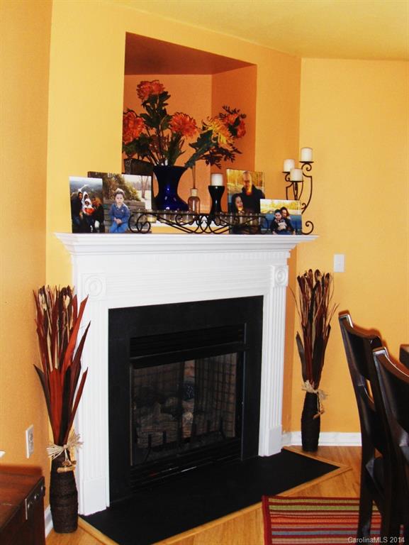 921 River Trail Road Lowell, NC 28098 - Photo 6 of 23 a living room with furniture a fireplace and wooden floor