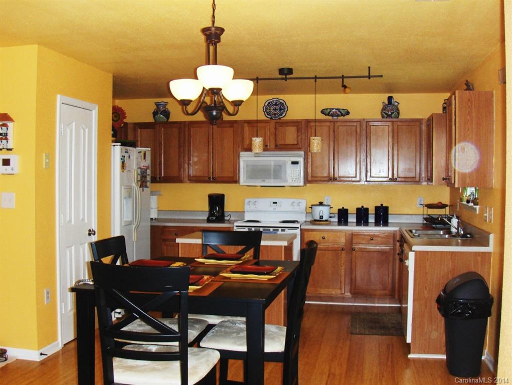 921 River Trail Road Lowell, NC 28098 - Photo 7 of 23 a kitchen with a table and chairs in it