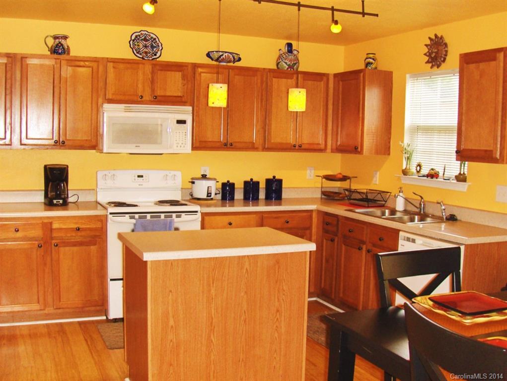 921 River Trail Road Lowell, NC 28098 - Photo 8 of 23 a kitchen with a sink a stove and a refrigerator