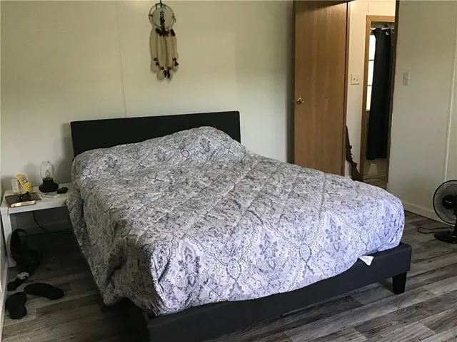 a bedroom with a bed and a dresser