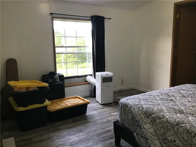 a bedroom with two beds and a window