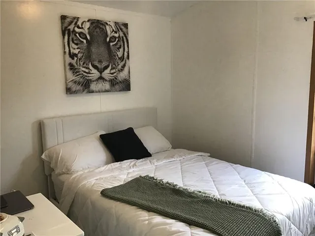 a bedroom with a bed and wall painting